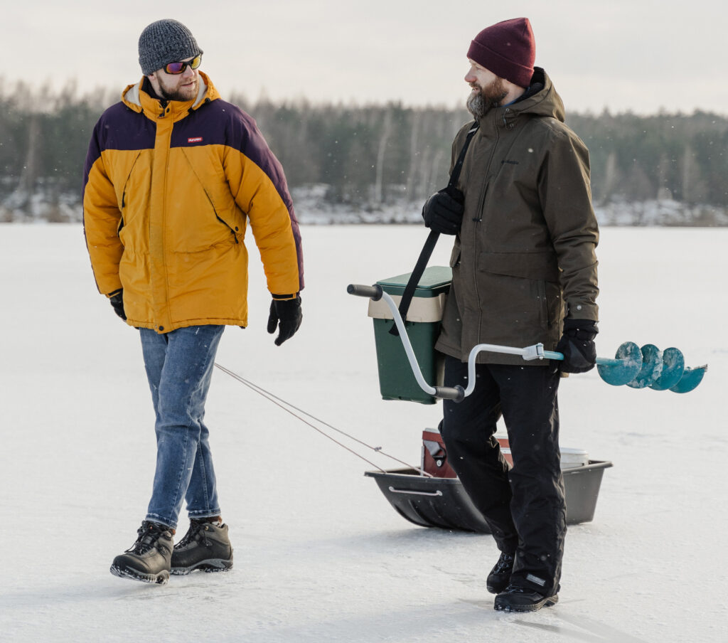 Two ice fishermen using different ice fishing lines.