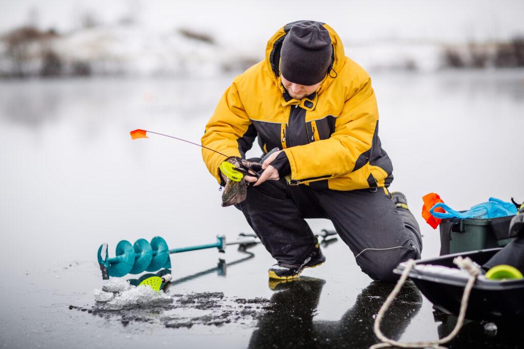 Ice fisherman using a short rod